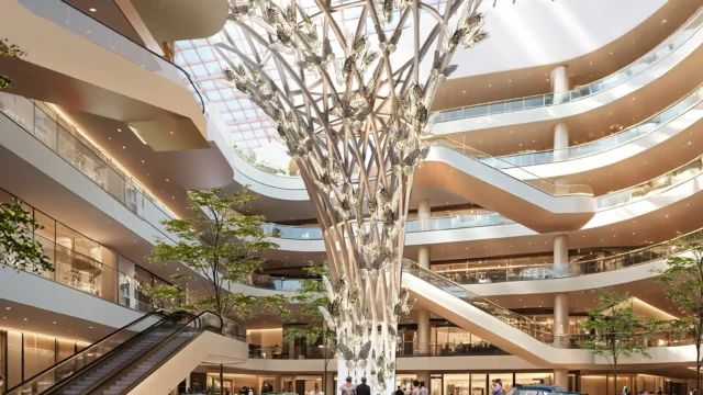 Artistic spiral sculpture under skylight in green indoor atrium of MVN Mall