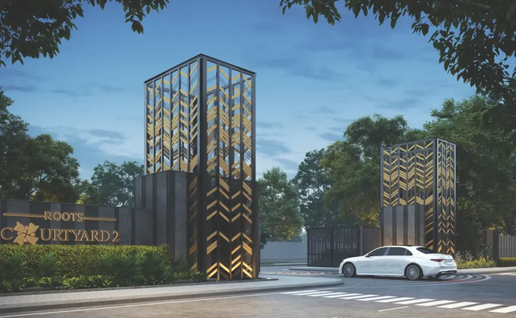 Grand entrance gate of Roots Courtyard 2 with vertical metal lattice towers and security check post