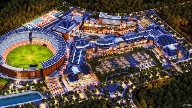 Aerial night view of Omaxe State Dwarka with cricket stadium, retail and commercial zones.
