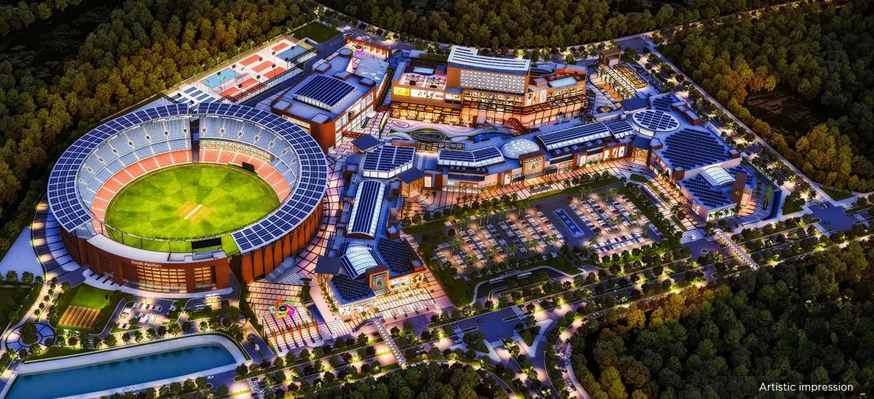 Aerial night view of Omaxe State Dwarka with cricket stadium, retail and commercial zones.