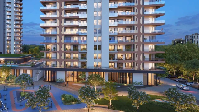Evening view of landscaped podium and building facade with jogging track, trees, and outdoor fitness zone at Twin Horizon